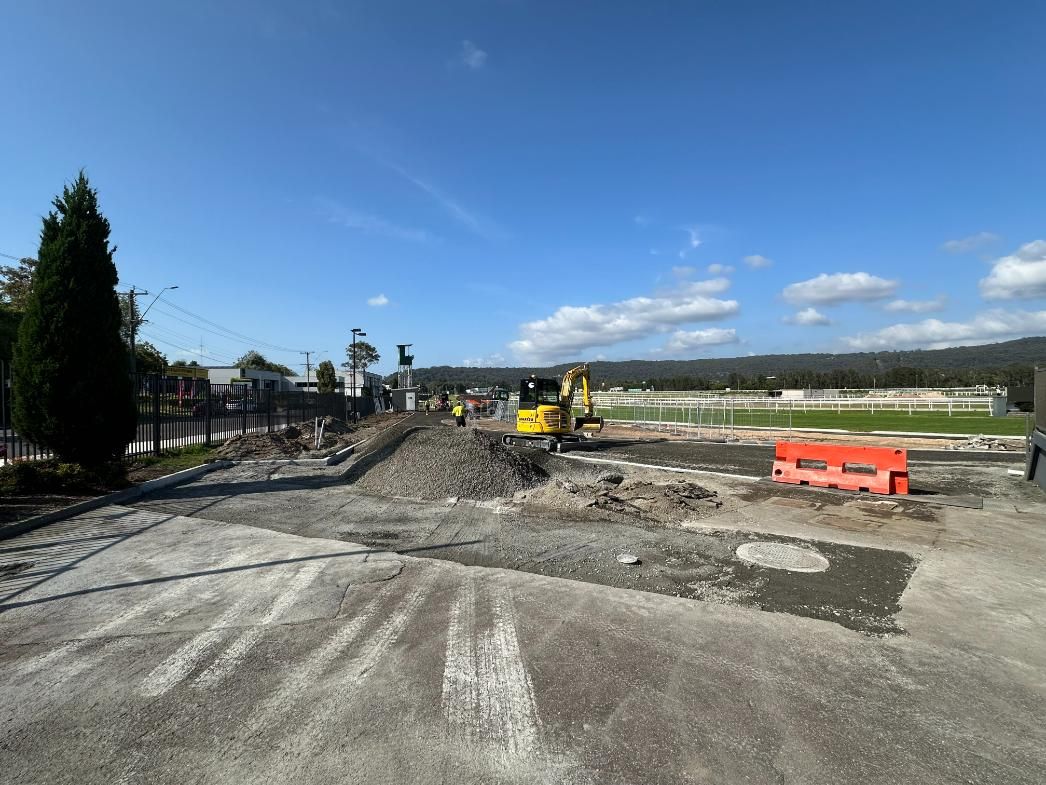 A Construction Site with A Yellow Excavator — Adam Lowe Earthmoving Pty Ltd in Somersby, NSW