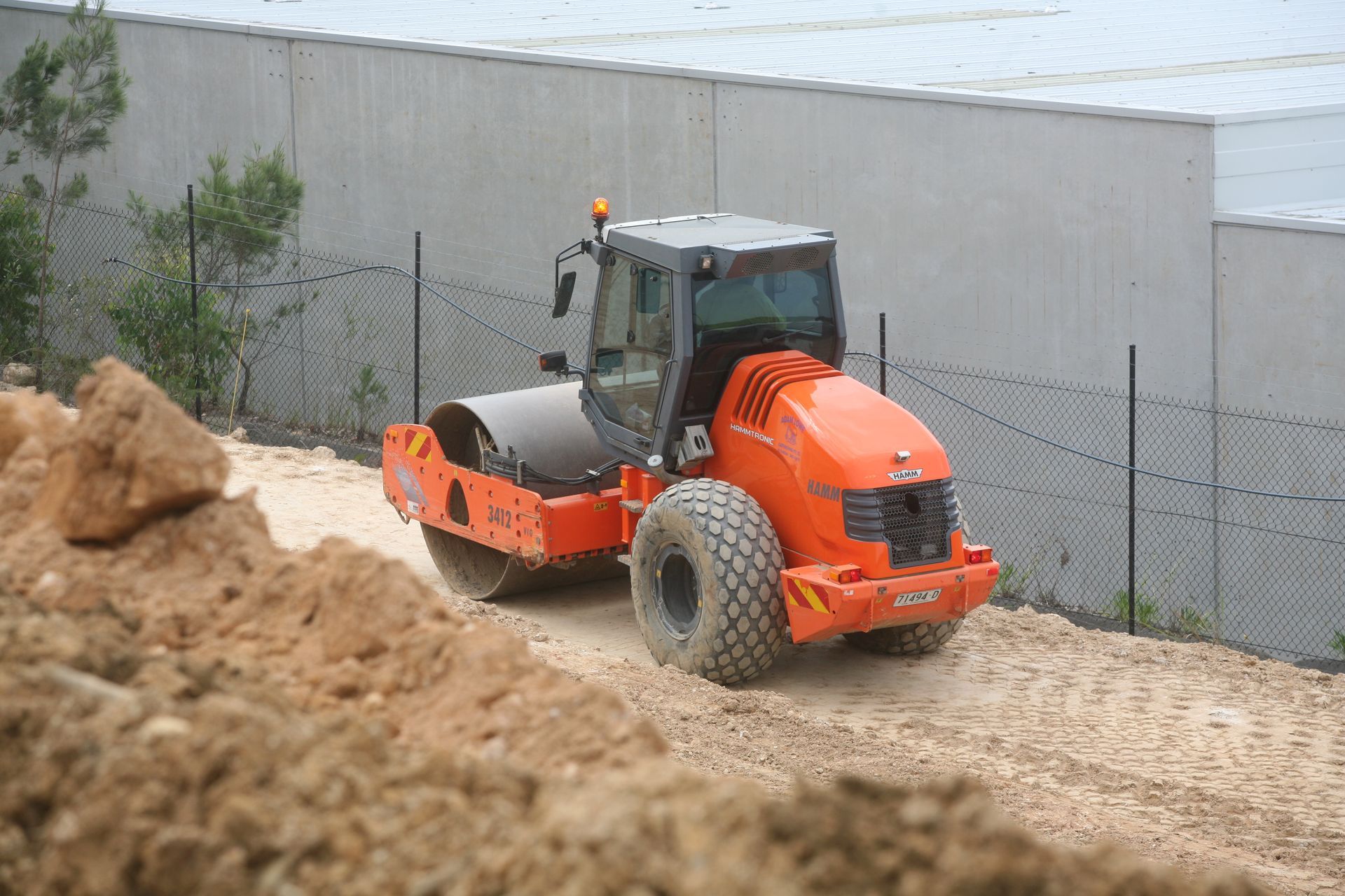 A Bulldozer Is Moving Dirt on A Hill — Adam Lowe Earthmoving Pty Ltd in Somersby, NSW