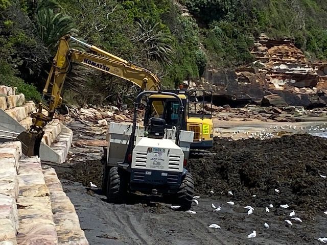 A Construction Site with A Yellow Excavator and Stairs — Adam Lowe Earthmoving Pty Ltd in Somersby, NSW