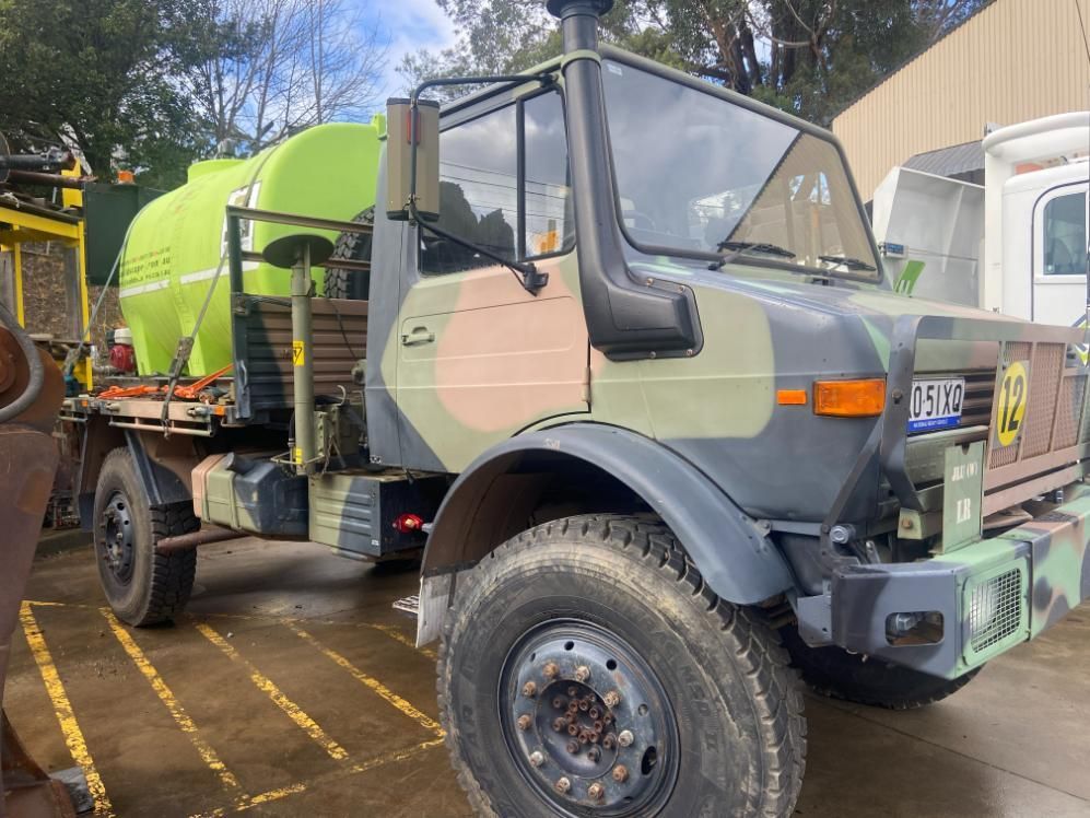 A Camouflage Truck with A Green Tank — Adam Lowe Earthmoving Pty Ltd in Somersby, NSW