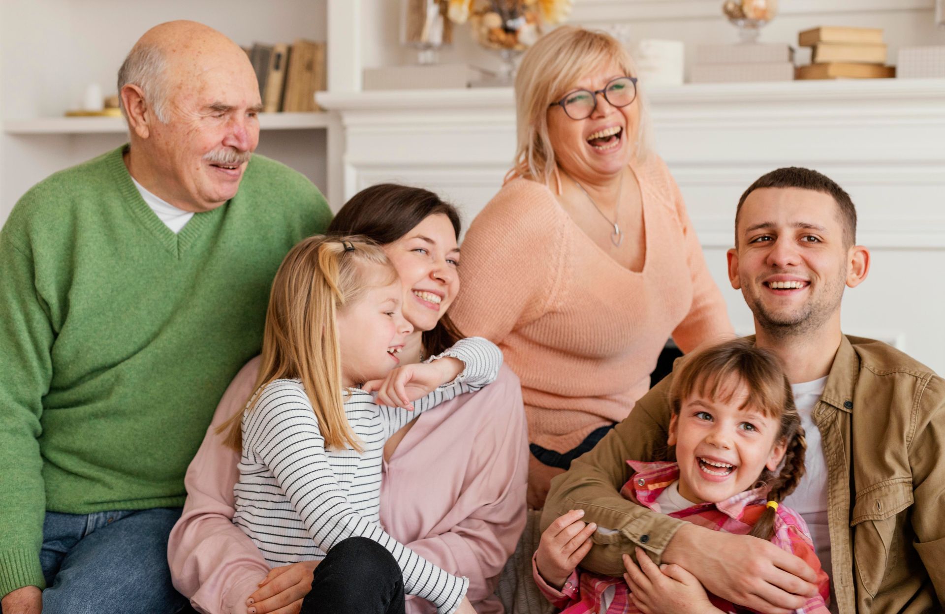 A family is posing for a picture together in a living room.