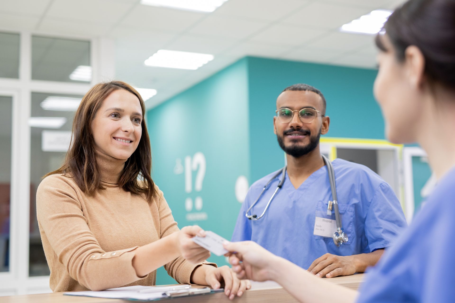 A nurse is giving a patient a prescription in a hospital.