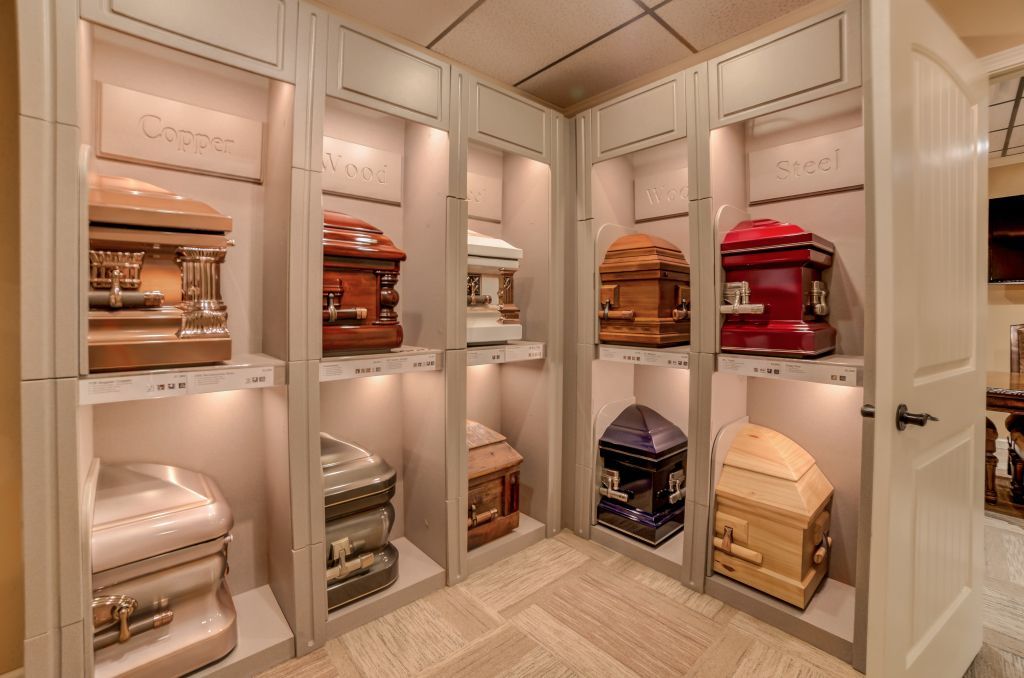 A room filled with lots of coffins on shelves.