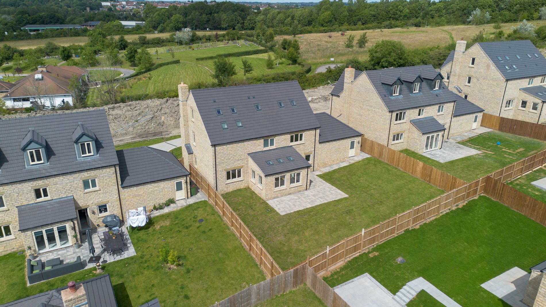 An aerial view of a residential area with houses and a fence.