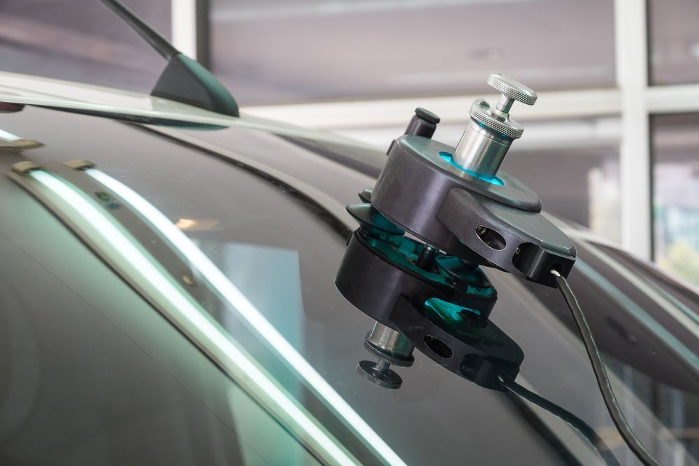 A car windshield is being repaired with a machine.