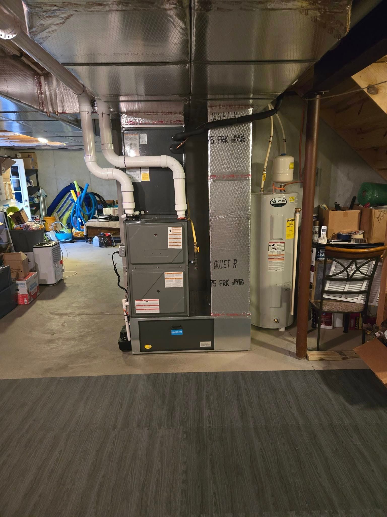 A basement with a heater and a water heater.