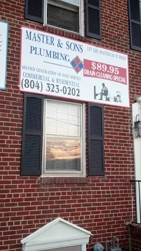 Sign for Master & Sons Plumbing on a brick building offering a drain cleaning special.