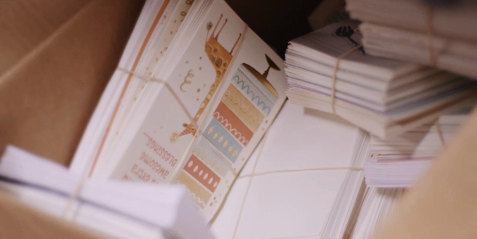 A box filled with stacks of cards and envelopes.