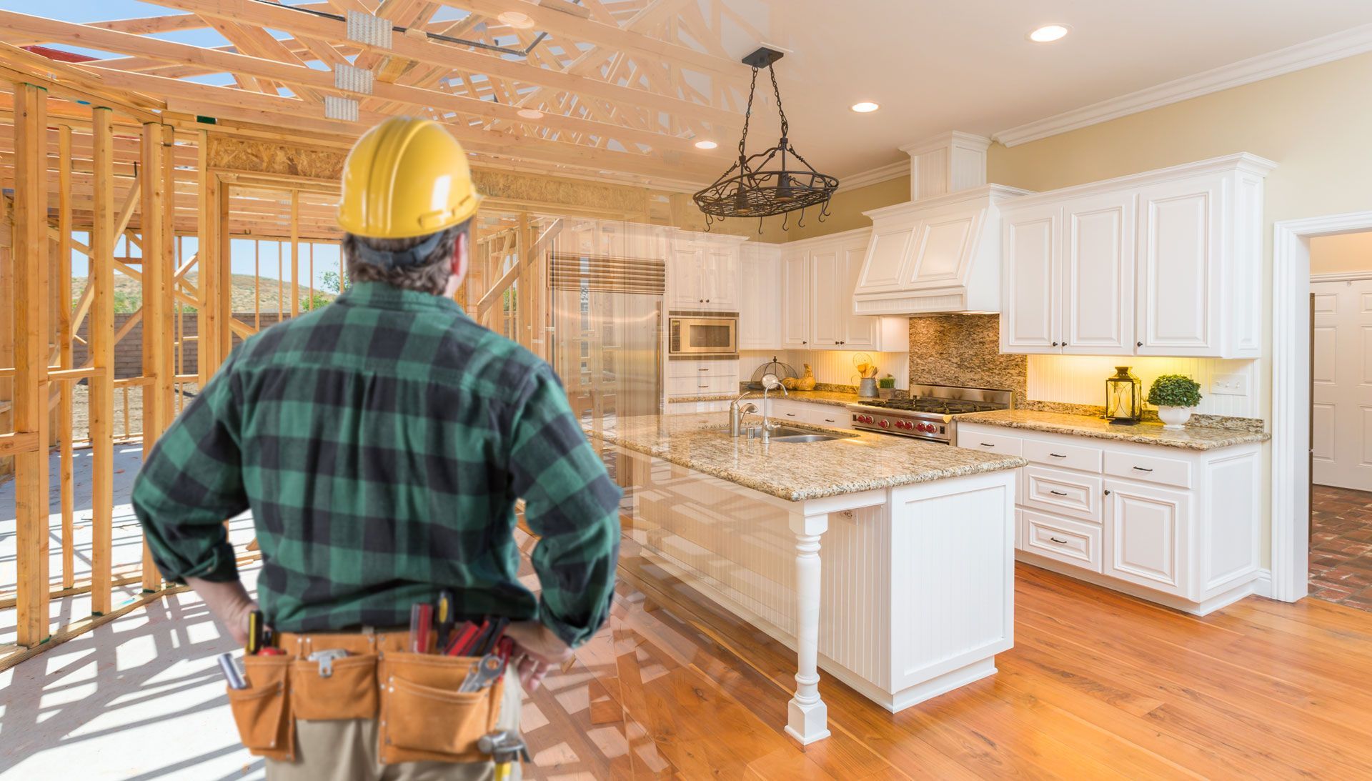 Construction worker in hard hat and tool belt looks at a partially built kitchen.