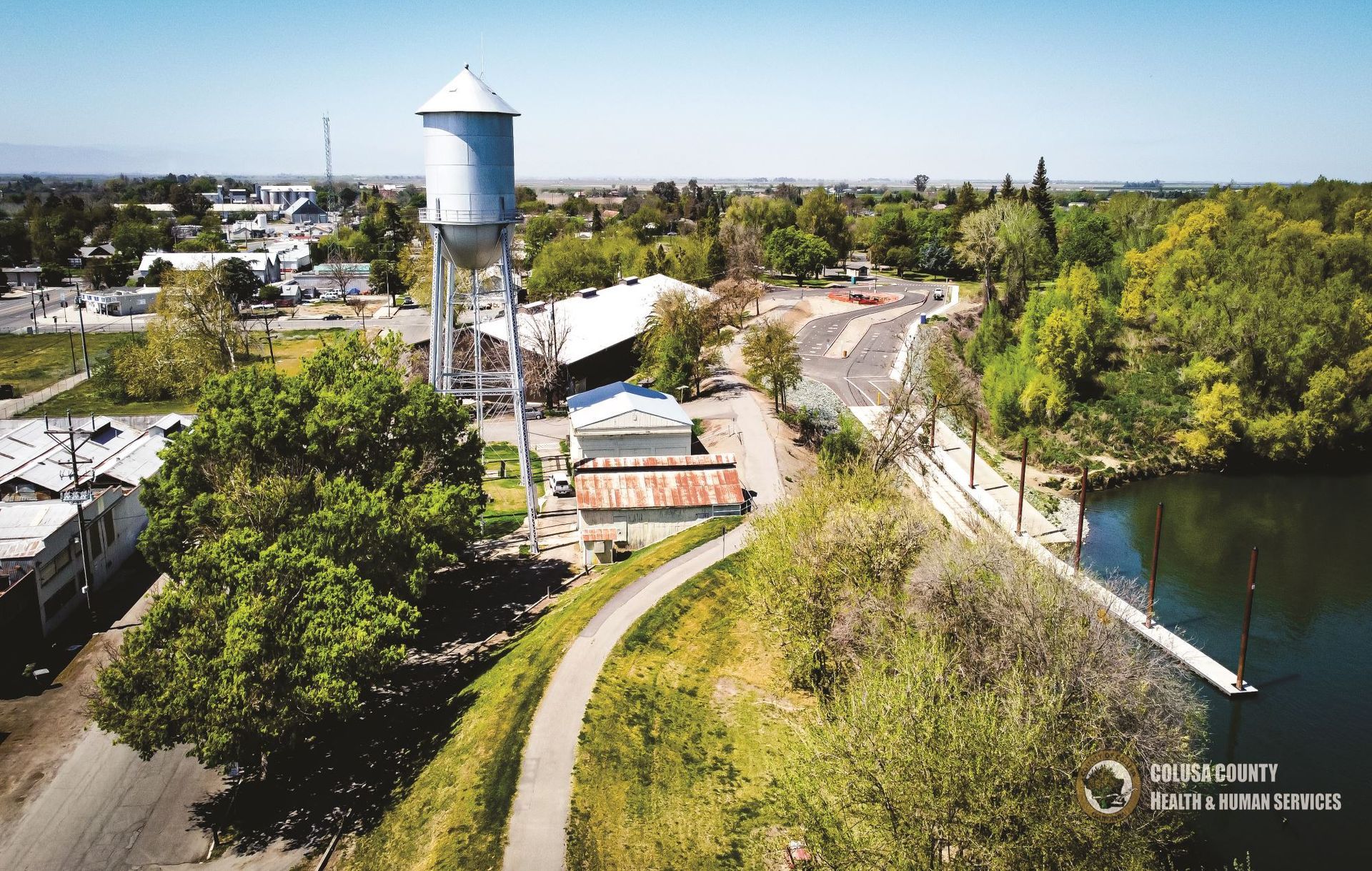 An aerial view of a water tower and a river