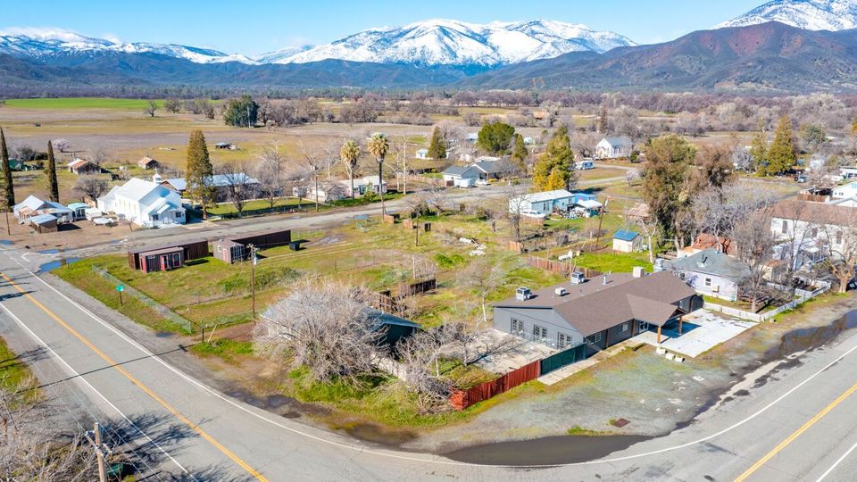 An aerial view of a small town with mountains in the background.