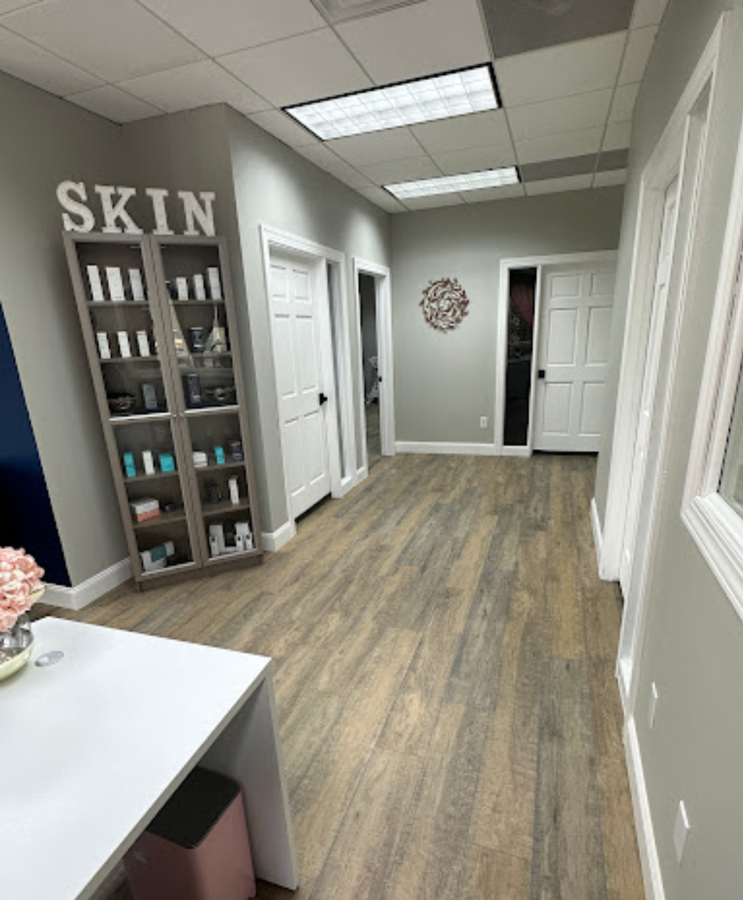 A long hallway with a sign that says skin on the wall.