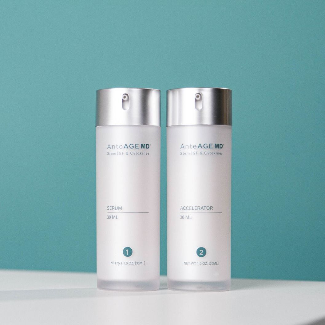 Two bottles of skincare products are sitting on a table.
