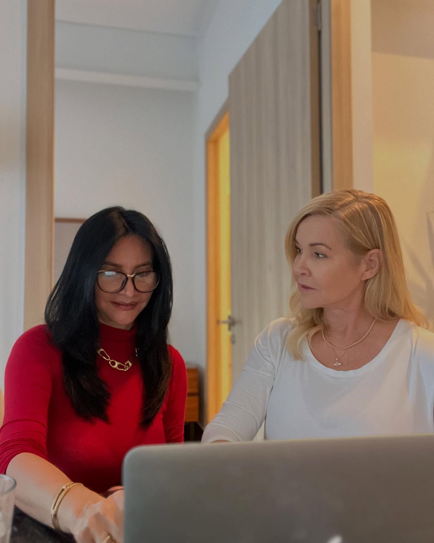 Two women looking at a laptop.