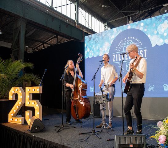 Band performs on stage at a festival with a 