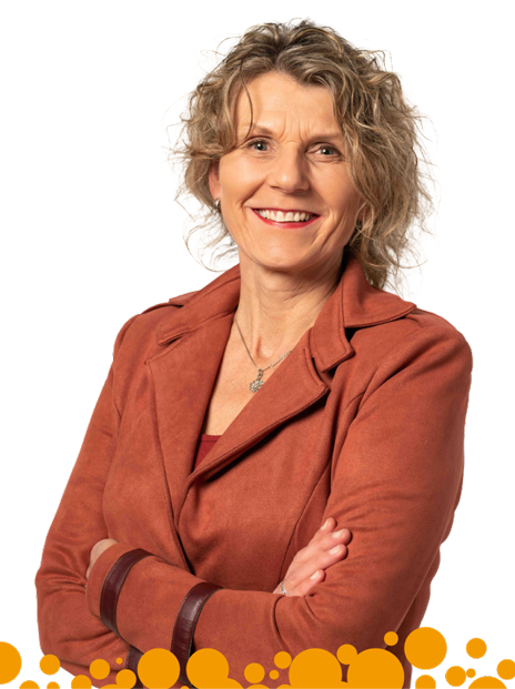 A woman in a red jacket is smiling with her arms crossed