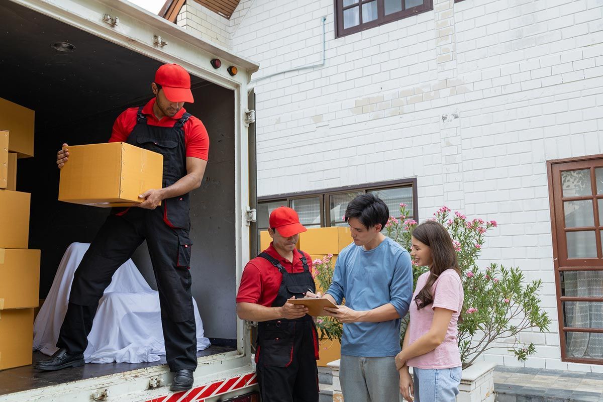 Professional movers carefully handling and transporting furniture during a residential move