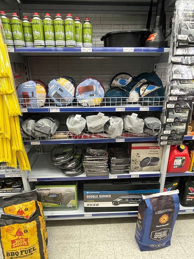 A Shelf in a Store Filled With Lots of Different Items — Pigglys Supermarket, Takeaway & Bottle Shop in The Gap, NT