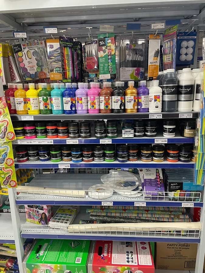 A Store Shelf Filled With Lots of Bottles of Paint — Pigglys Supermarket, Takeaway & Bottle Shop in The Gap, NT