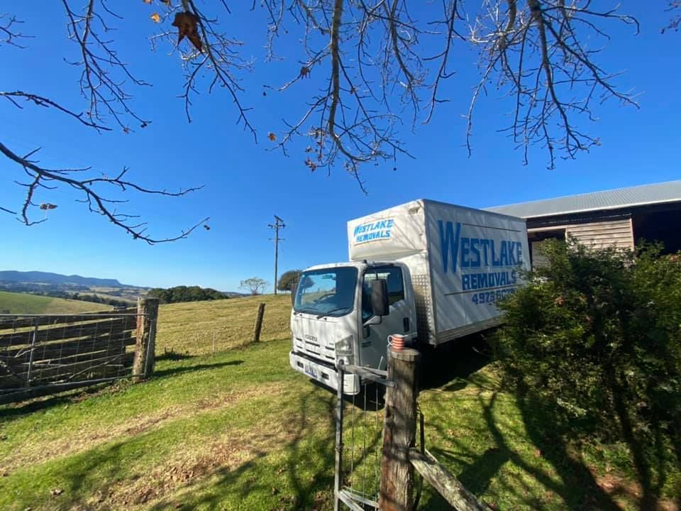 Moving Truck Parked by A Field, with The Westlake Removals Logo on The Side — Westlake Removals in Wyee, NSW