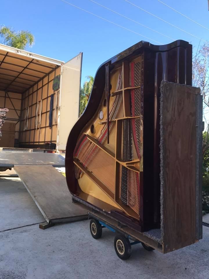 A Piano Being Moved onto A Truck via A Ramp. the Piano Is on A Dolly — Westlake Removals in Morisset, NSW