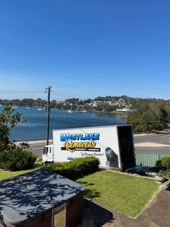 Moving Truck with Open Back Near a Body of Water and Boats — Westlake Removals in Morisset, NSW