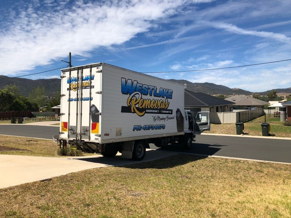 White Moving Truck, Westlake Removals Logo, Parked on A Residential Street — Westlake Removals in Morisset, NSW