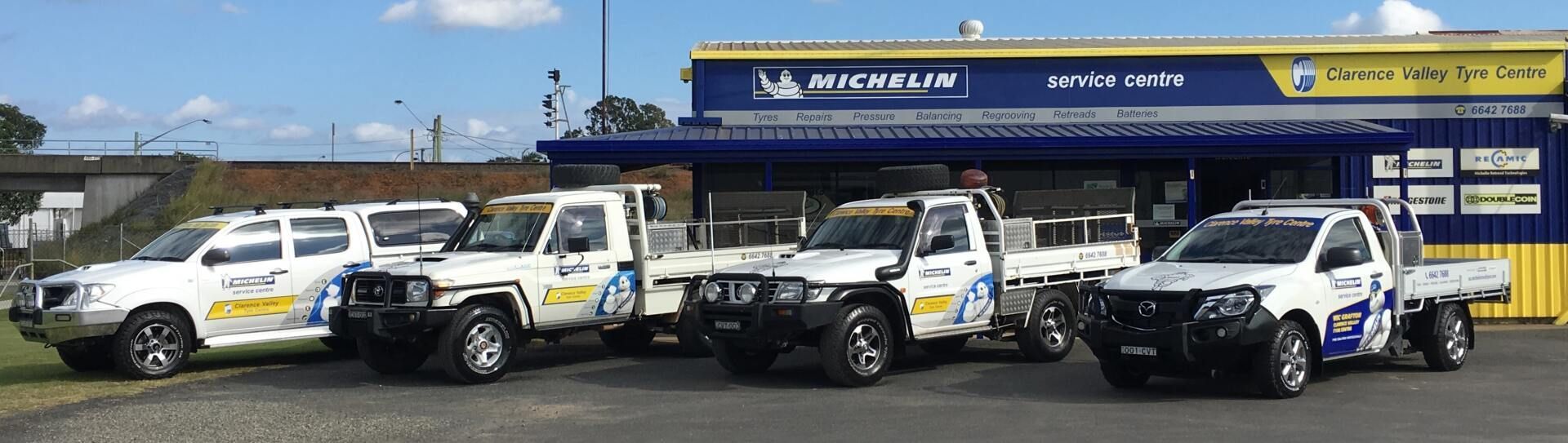 A Row Of White Trucks Are Parked In Front Of A Building — Clarence Valley Tyre Centre in South Grafton, NSW