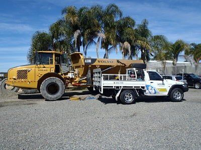 A work ute next to a Volvo bulldozer  — Clarence Valley Tyre Centre in South Grafton, NSW