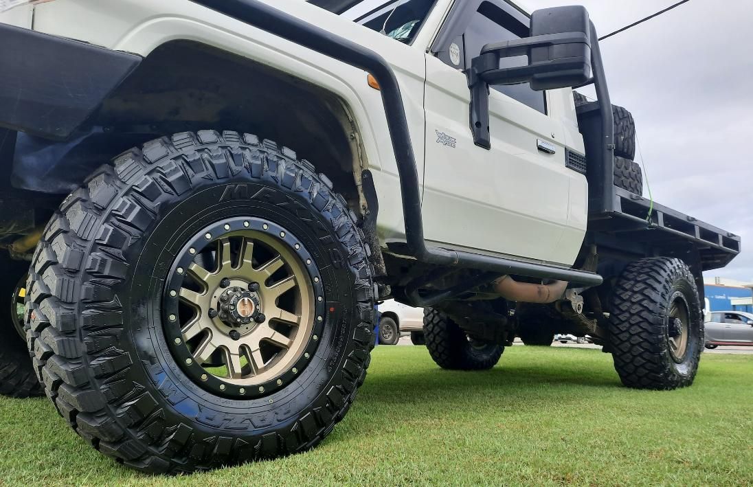 A White Truck Is Parked On A Lush Green Field — Clarence Valley Tyre Centre in South Grafton, NSW