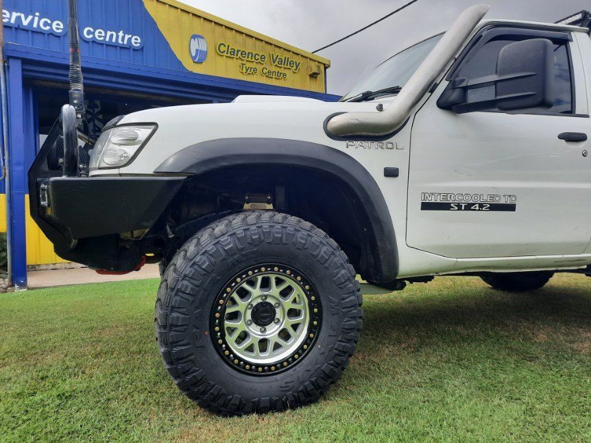 A White Truck With A Snorkel Is Parked In Front Of A Service Center — Clarence Valley Tyre Centre in South Grafton, NSW