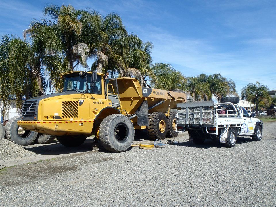 A Blue Semi Truck Is Parked In Front Of A Building — Clarence Valley Tyre Centre in South Grafton, NSW
