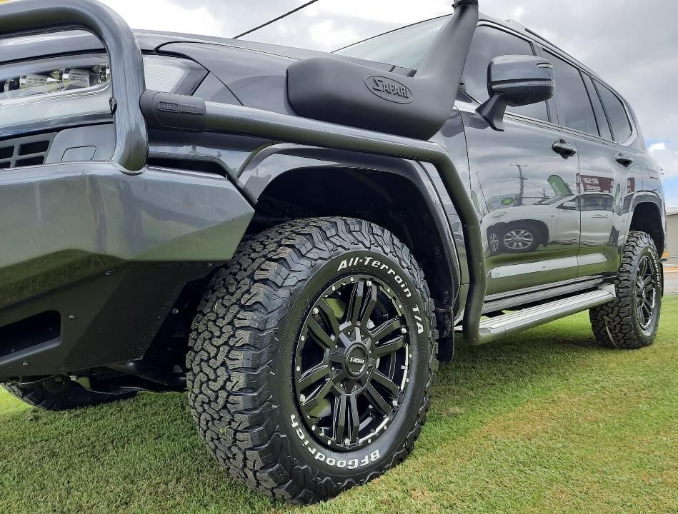 A Black SUV Is Parked On A Lush Green Field — Clarence Valley Tyre Centre in South Grafton, NSW