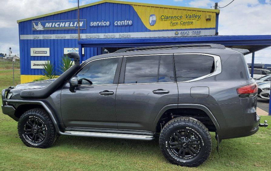 A Toyota Land Cruiser Is Parked In Front Of A Blue Building — Clarence Valley Tyre Centre in South Grafton, NSW