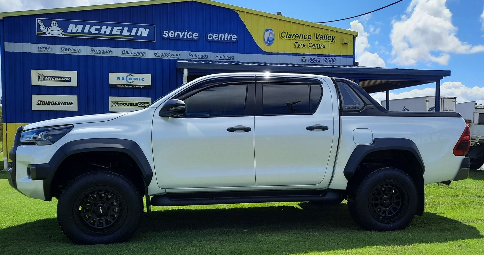 White Truck Parked Outside A Yellow Shop— Clarence Valley Tyre Centre in South Grafton, NSW