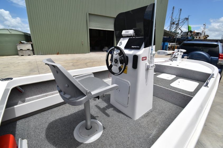 A Boat With a Steering Wheel and a Chair on the Deck — Sandy Straits Marine In Urangan, QLD