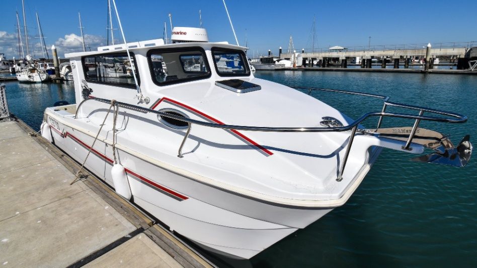 A White Boat is Docked at a Dock in a Marina — Sandy Straits Marine In Urangan, QLD