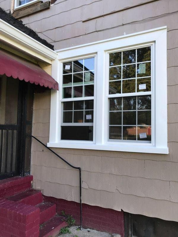 A house with two windows and a red awning