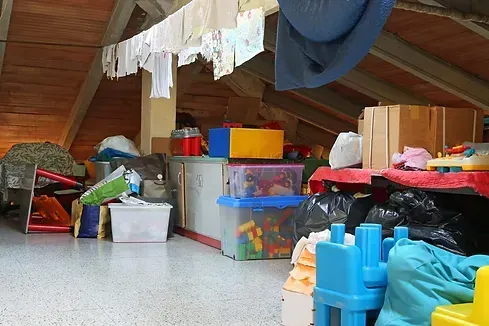 An attic filled with lots of boxes and toys
