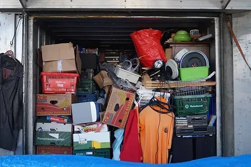 A garage filled with lots of boxes and clothes