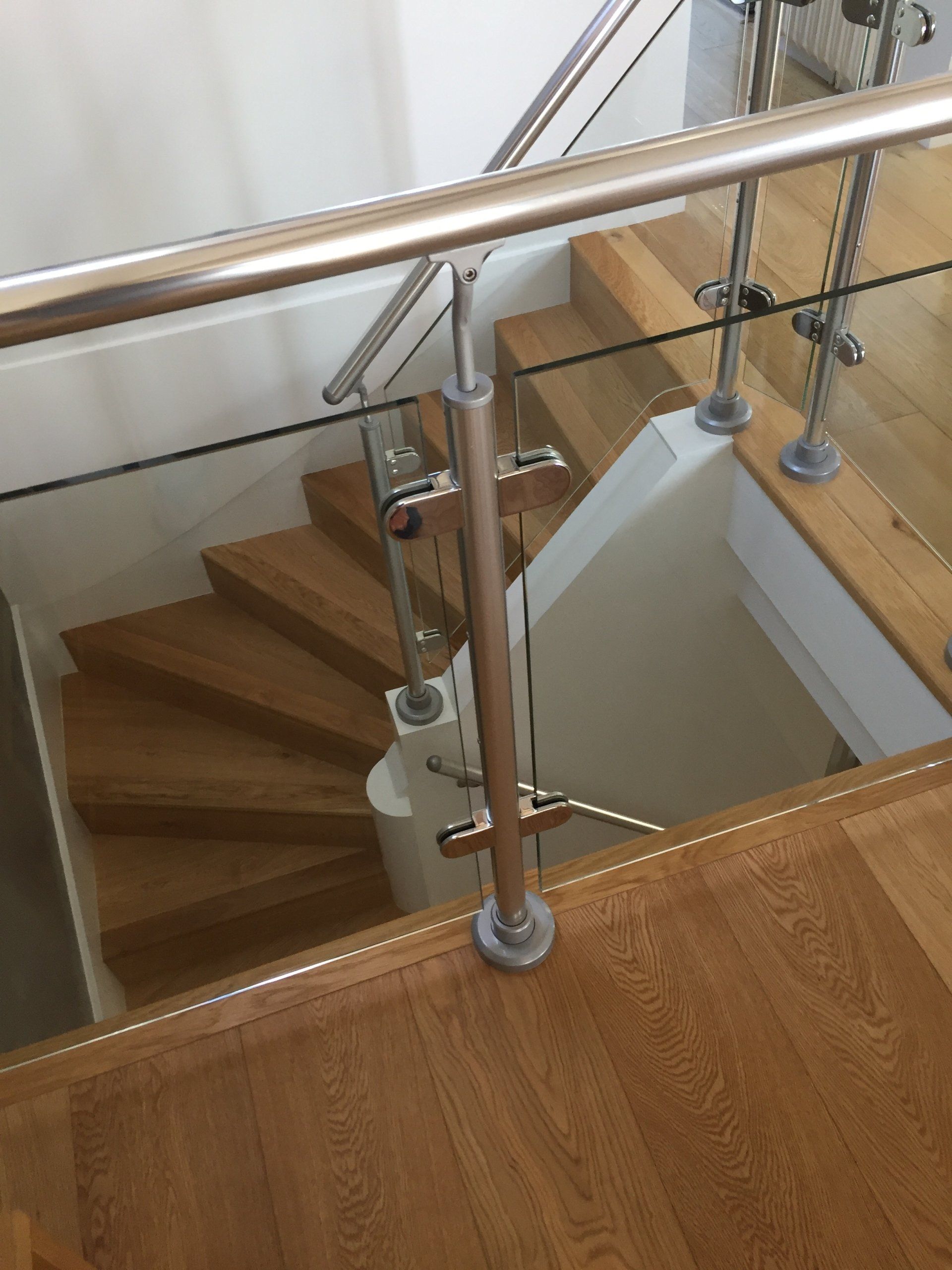 A staircase with a glass railing and wooden steps