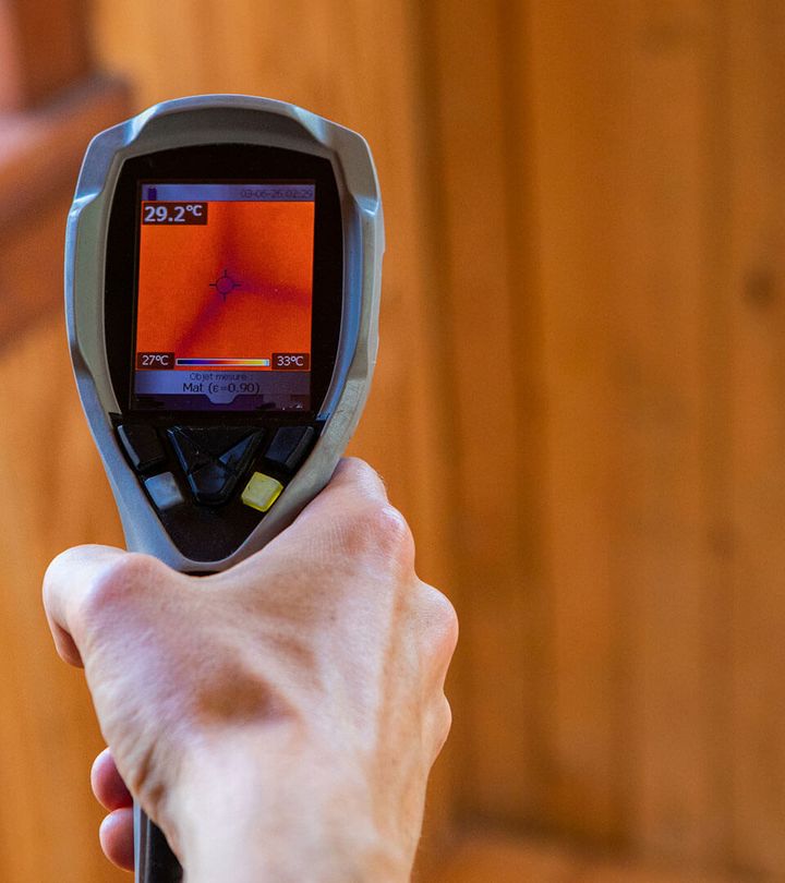 a person is holding a thermal camera in their hand .