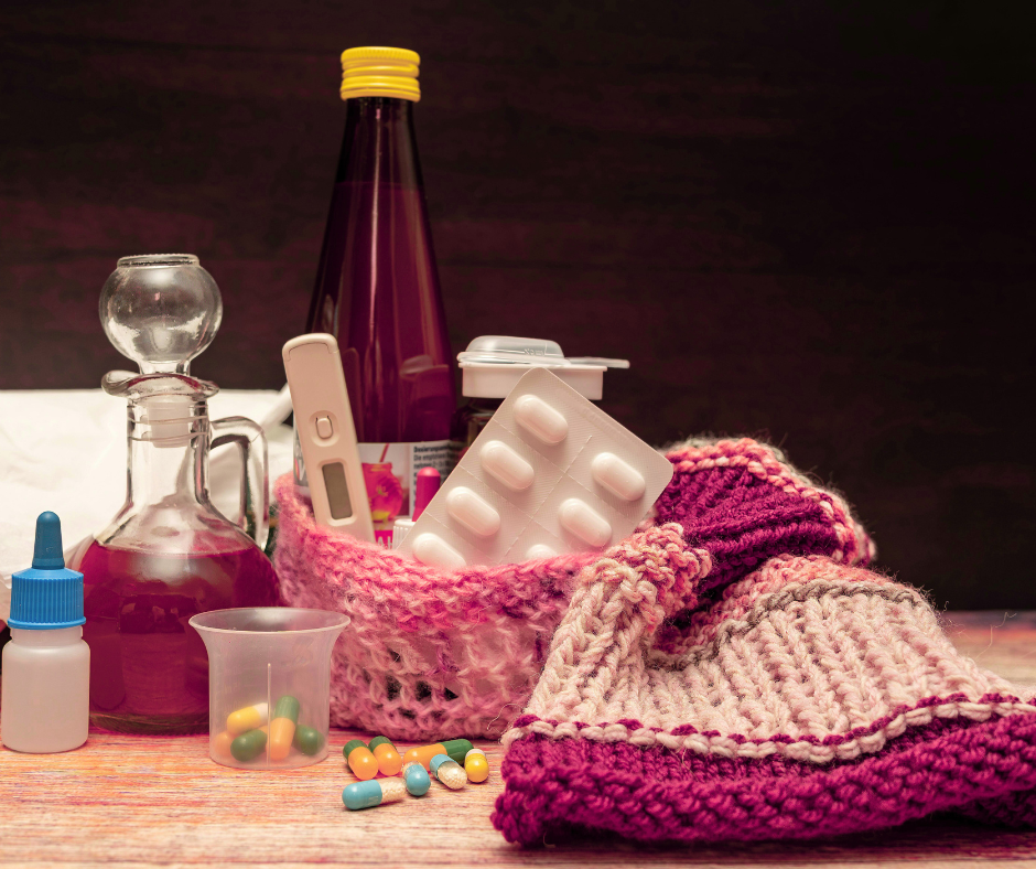 Sick day essentials: medications, thermometer, cough syrup, hat, and cough drops.