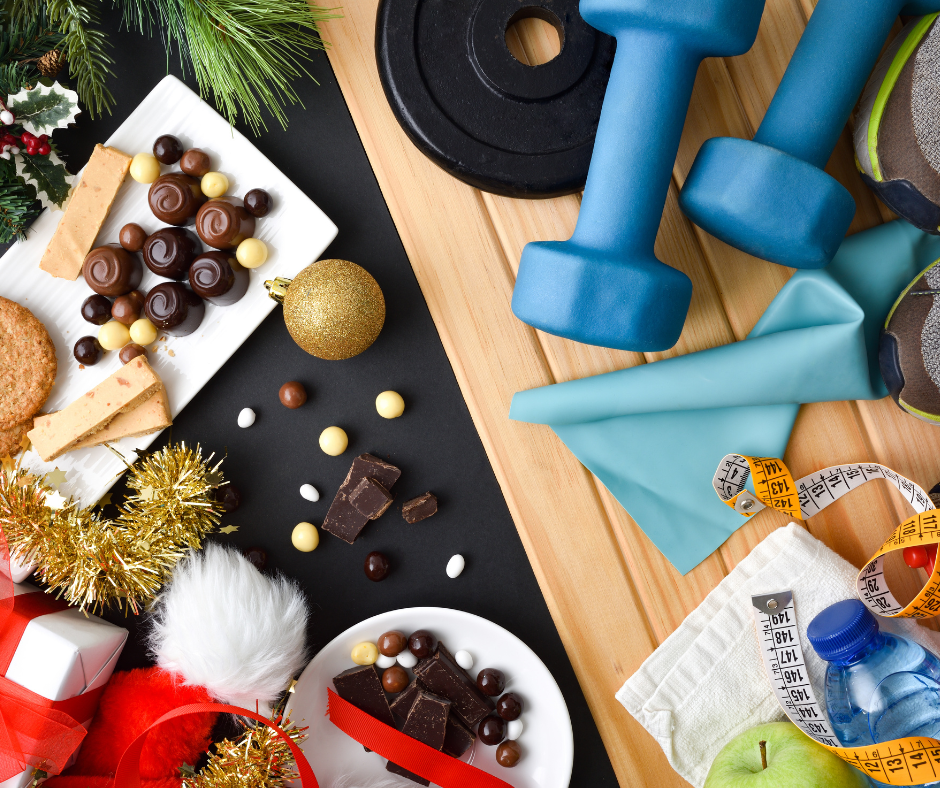 Festive flatlay: Treats, weights, and water bottle symbolize holiday balance of indulgence and fitness.