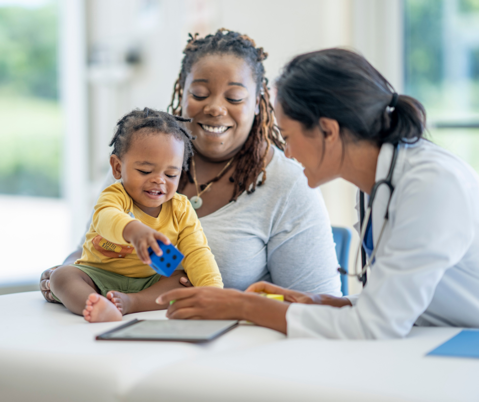 picture of smiling mother and child with health care provider