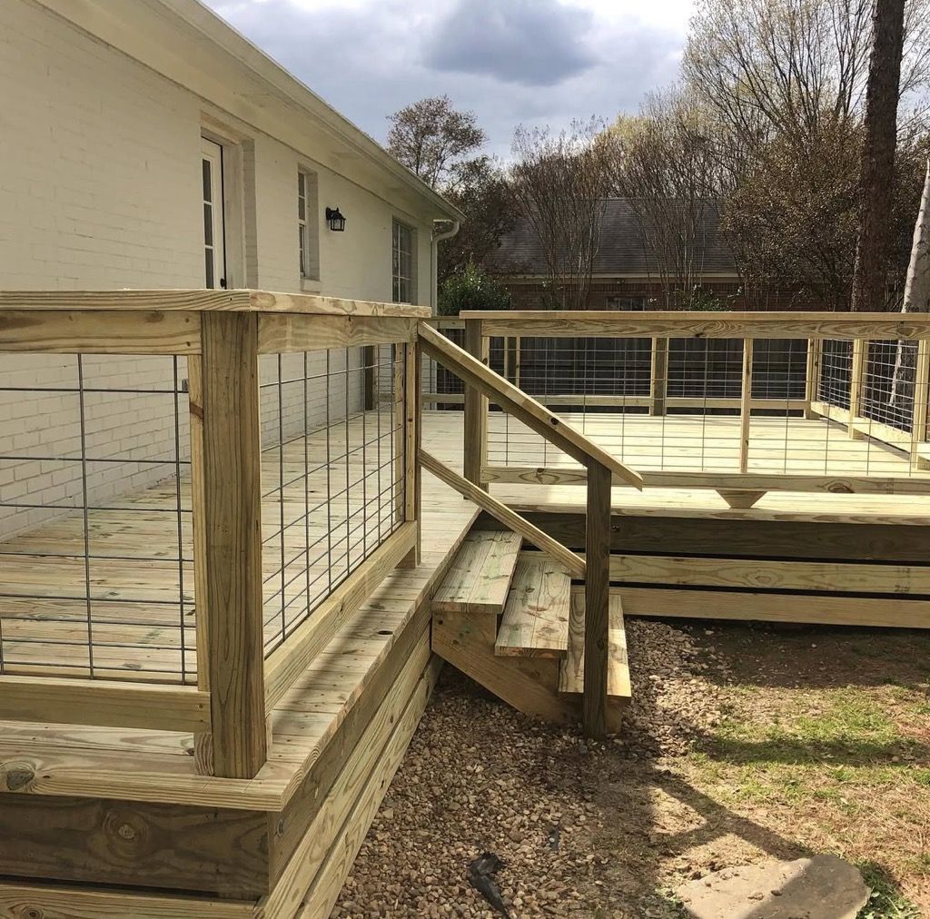 A wooden deck with stairs leading up to it