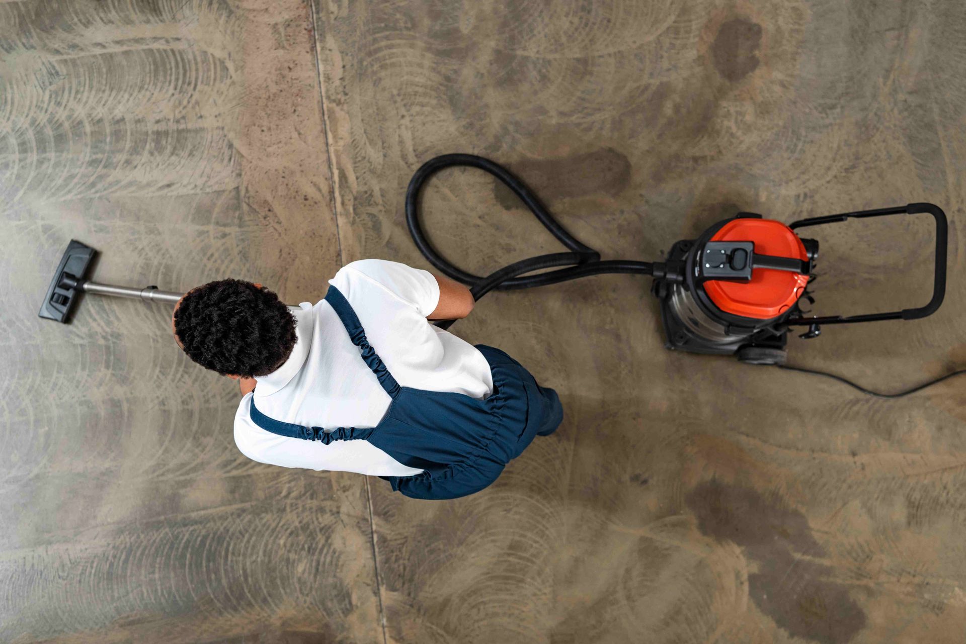 a man is cleaning the floor with a vacuum cleaner