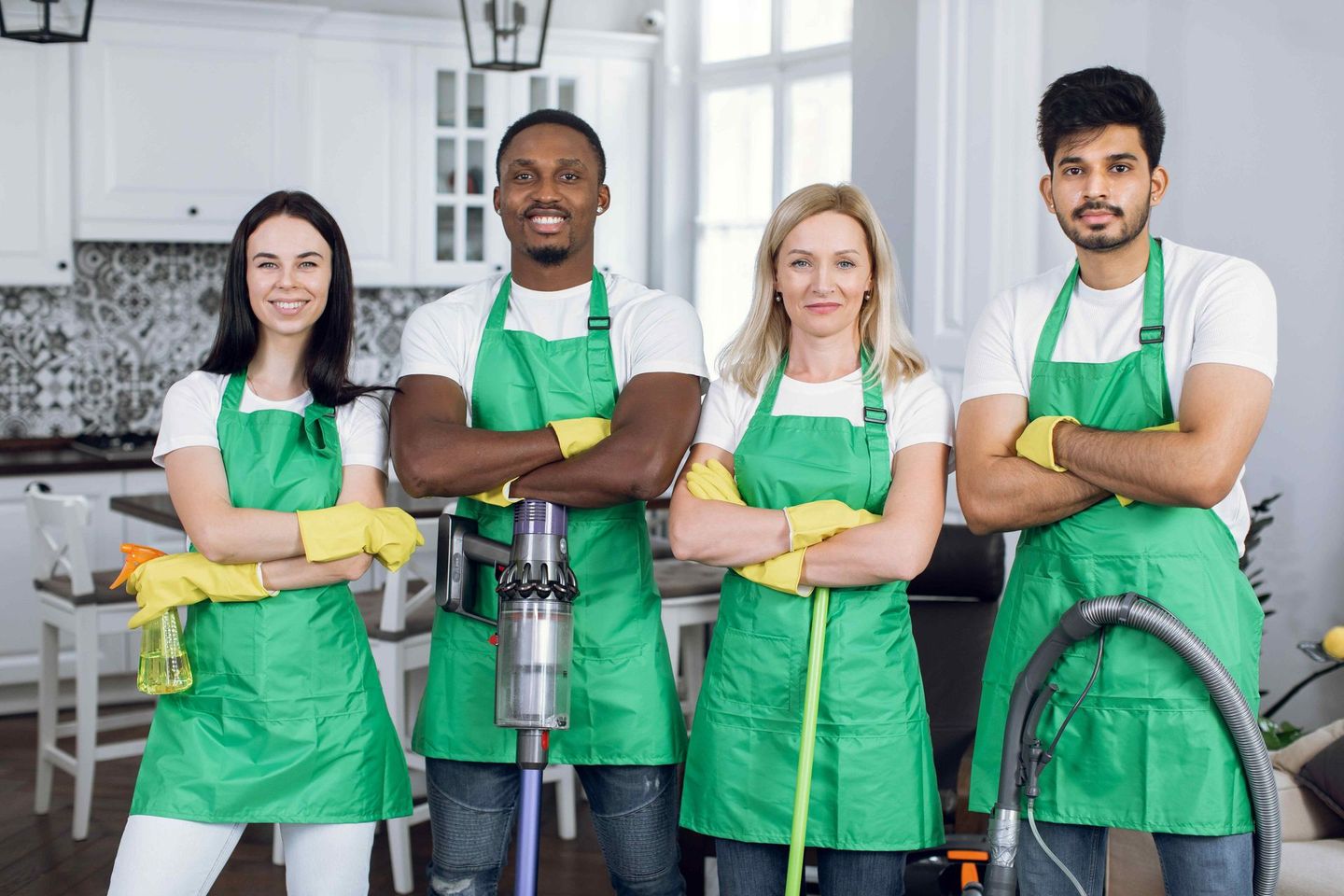 a group of cleaners are posing for a picture in a kitchen 
