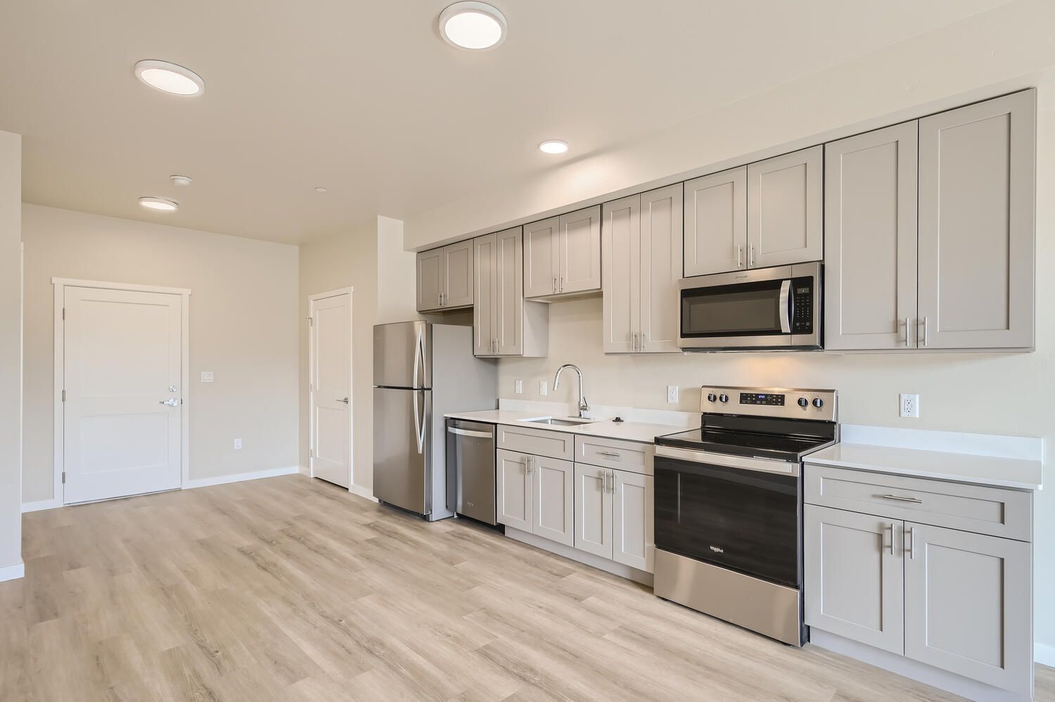 a kitchen with stainless steel appliances and white cabinets