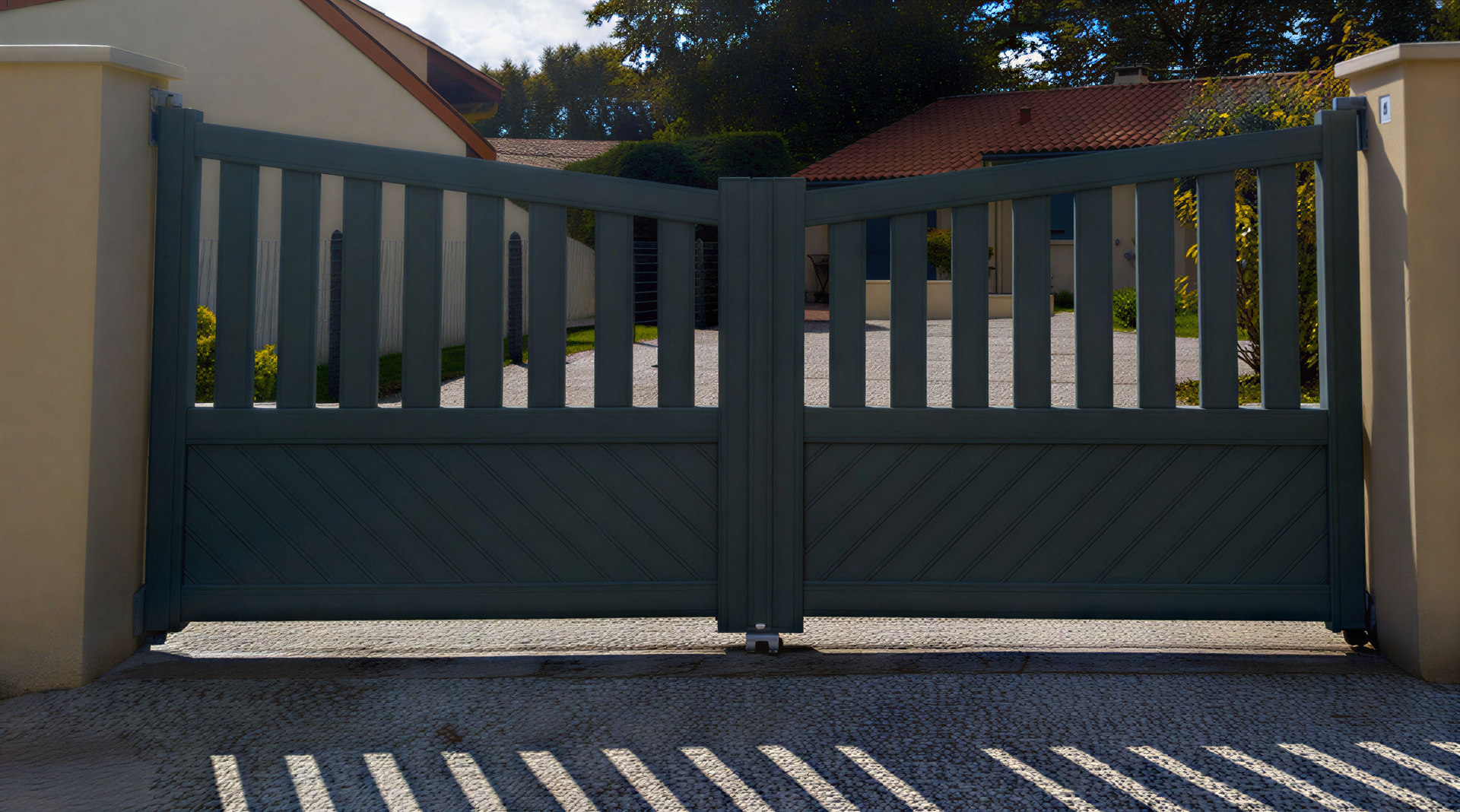 Dark green wooden double gate, open, set in stone pillars, driveway in front.